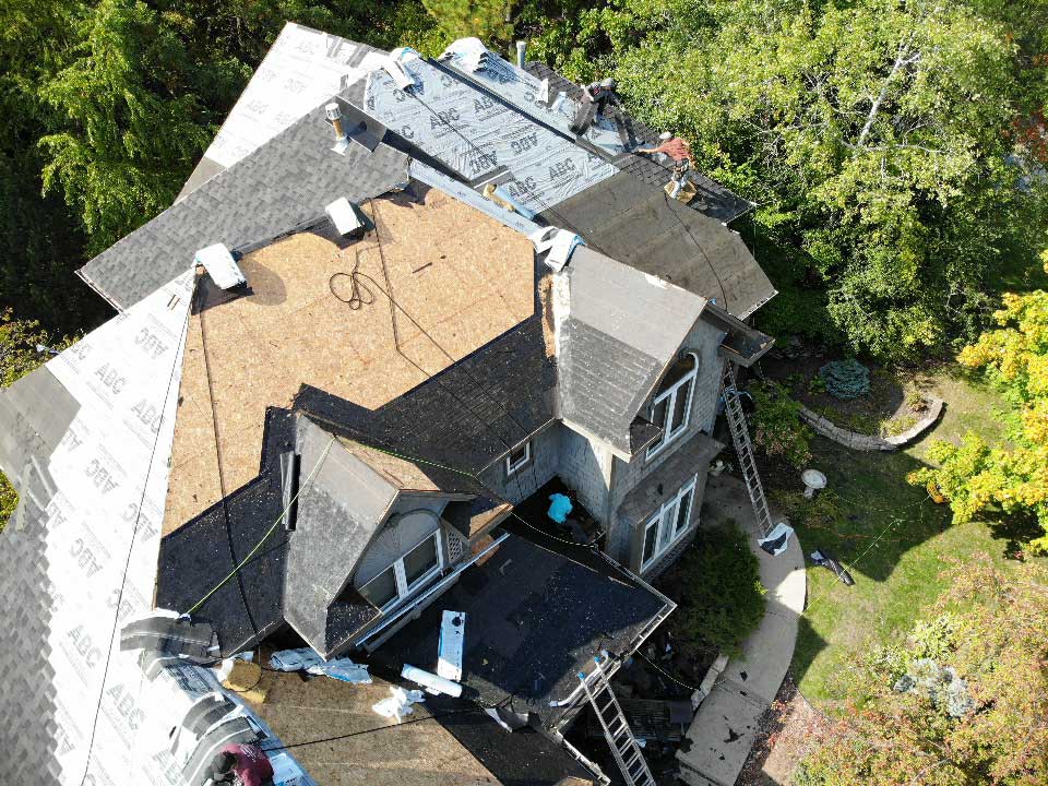 Drone photo of an in progress roofing job from the side