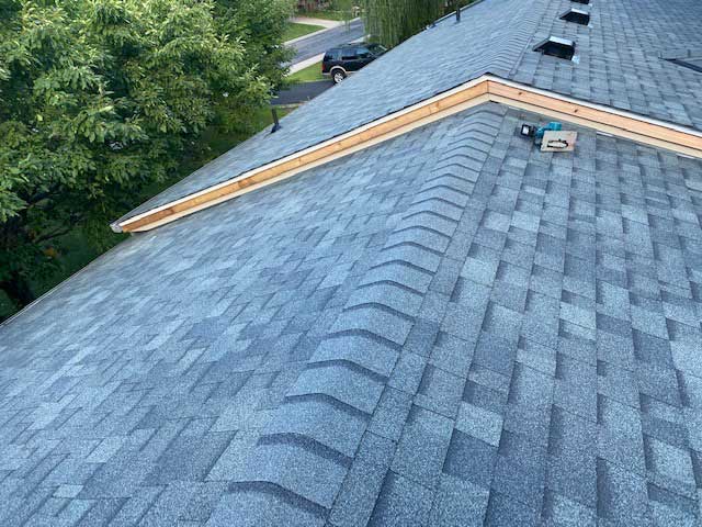 After photo of a roofing work with grey shingles