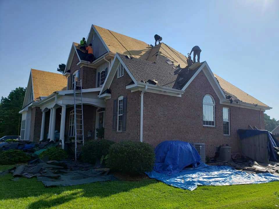 Roof Replacement in progress on a brick house