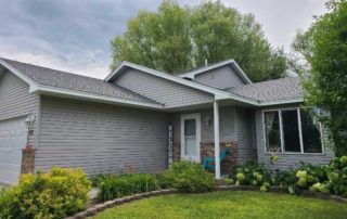 Patriot Homes done siding and roof work on a grey house