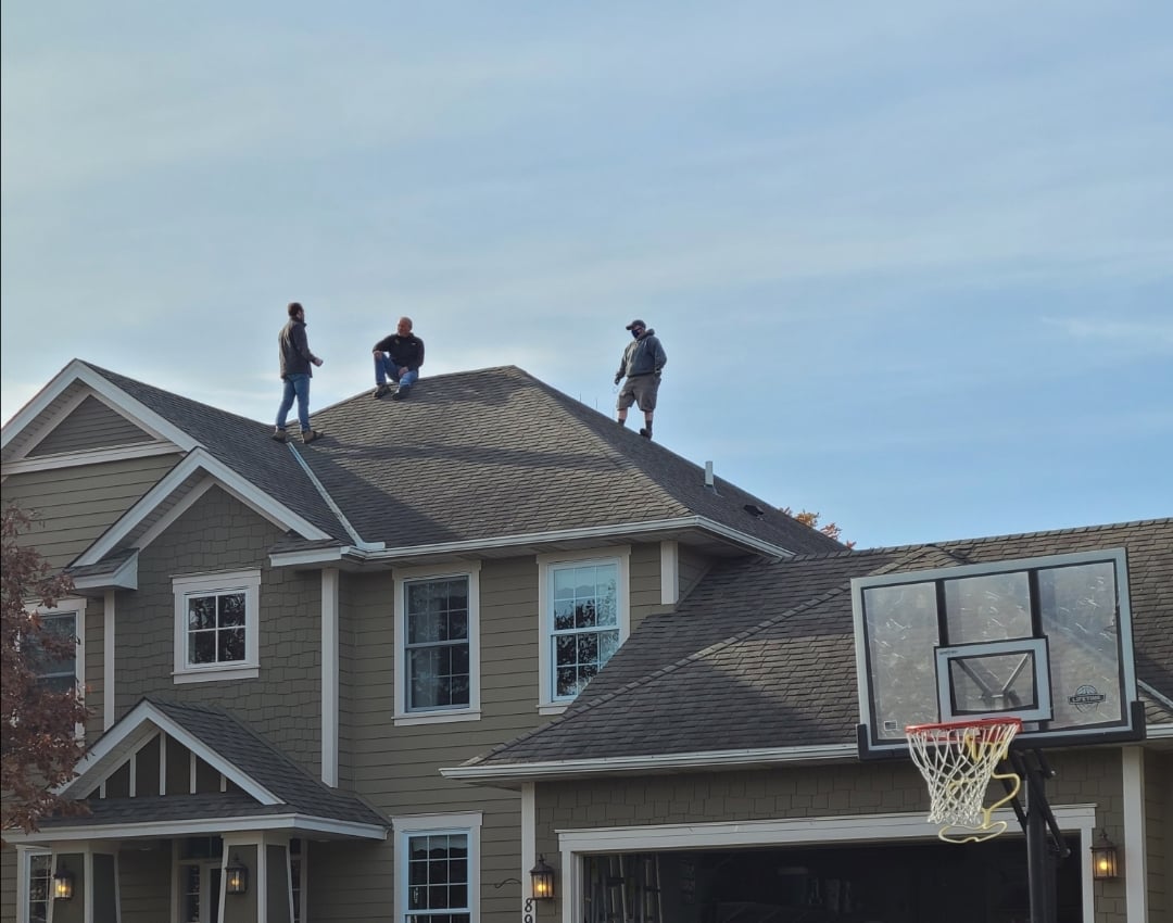 Patriot Home Professionals examining the roof