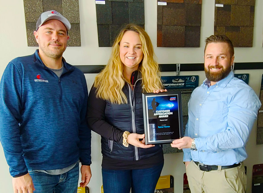 Patriot Homes owner accepting award for customer service.